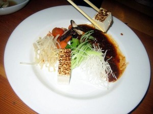 eating Sanraku spicy tofu appetizer