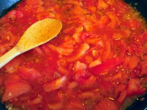 simmering prepared tomatoes in reduced court bouillon